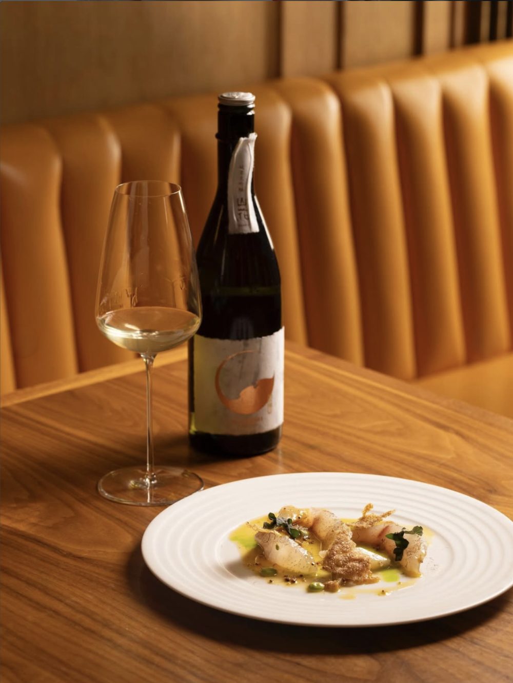 A glass of wine and a plate at Trivet