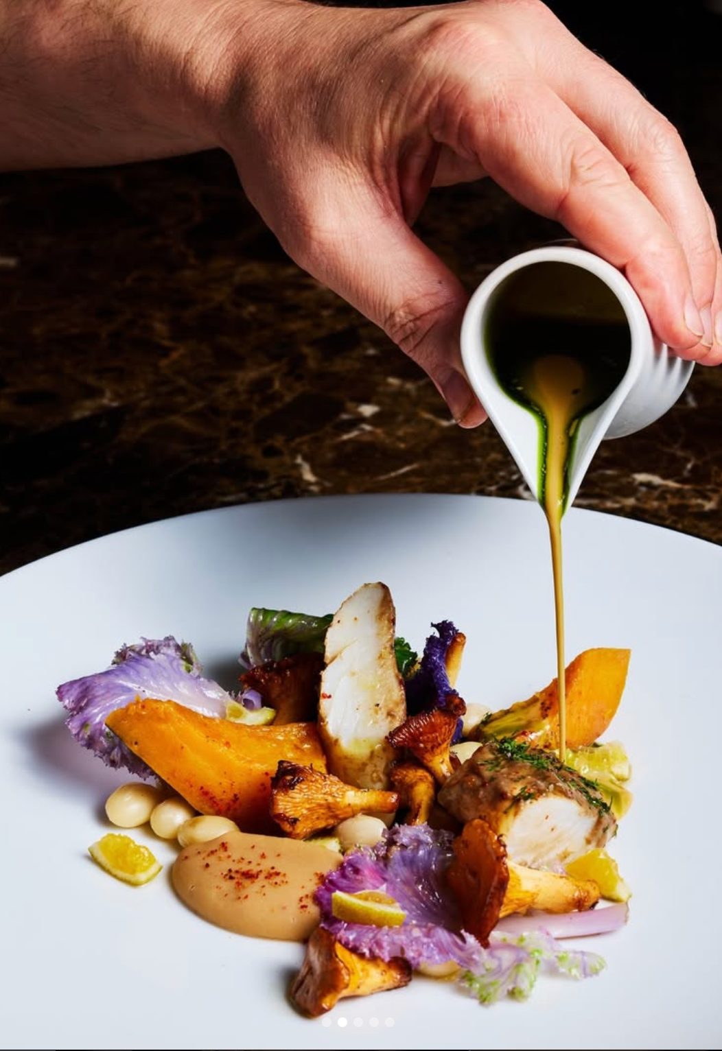 A chef finishing a dish at Trivet